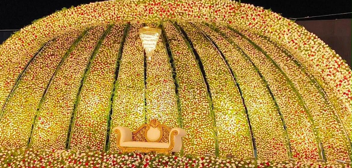 Floral dome reception stage decorated by Naveen Events & Caterers