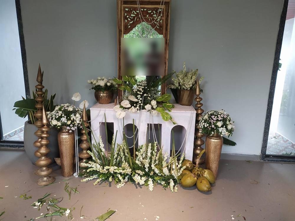 Seemantham ceremony setup with carved mirror, brass vases and white flowers