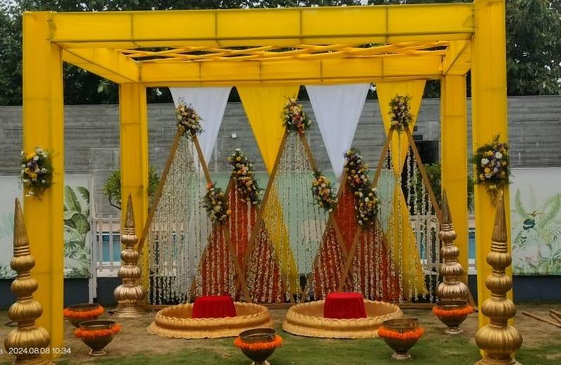 Yellow haldi mandap with marigold garlands